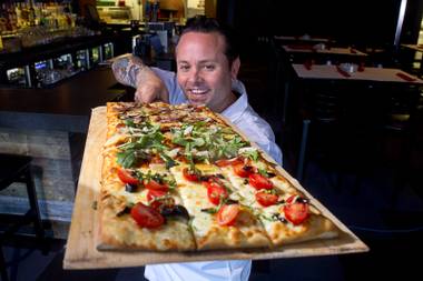 Tony Gemignani holds a Roman pizza at the new Pizza Rock restaurant at Third Street and Ogden Avenue in downtown Las Vegas Thursday, Oct. 17&nbsp;2013.