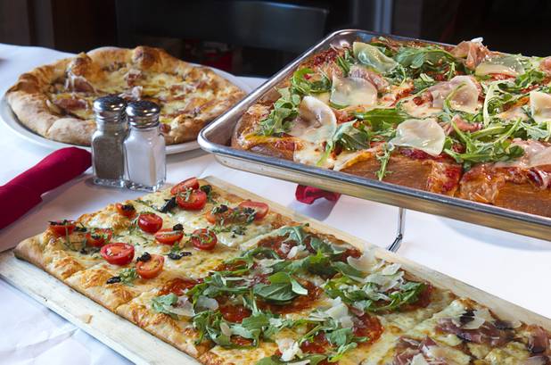 Pizzas, clockwise from top left, Cal Italia, Sicilian and a Roman, at the new Pizza Rock restaurant at Third Street and Ogden Avenue in downtown Las Vegas Thursday, Oct. 17 2013.