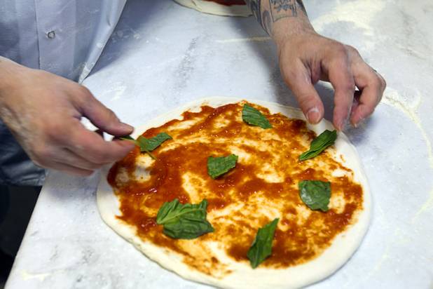 Tony Gemignani makes a margherita pizza at the new Pizza Rock restaurant at Third Street and Ogden Avenue in downtown Las Vegas Thursday, Oct. 17 2013.