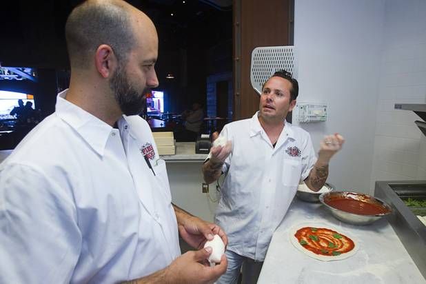 Las Vegas Weekly food editor Brock Radke, left listens to Tony Gemignani as they make margherita pizzas at the new Pizza Rock restaurant at Third Street and Ogden Avenue in downtown Las Vegas Thursday, Oct. 17 2013.