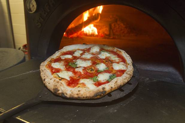 A margherita pizza comes out of a wood-fired oven at the new Pizza Rock restaurant at Third Street and Ogden Avenue in downtown Las Vegas Thursday, Oct. 17 2013.