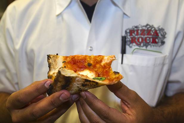 Las Vegas Weekly food editor Brock Radke eats a margherita pizza just out of the oven at the new Pizza Rock restaurant at Third Street and Ogden Avenue in downtown Las Vegas Thursday, Oct. 17 2013.