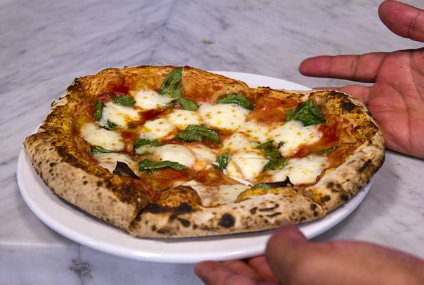 A margherita pizza made by Las Vegas Weekly food editor Brock Radke is shown at the new Pizza Rock restaurant at Third Street and Ogden Avenue in downtown Las Vegas Thursday, Oct. 17 2013.