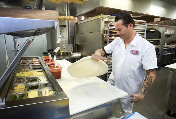 Tony Gemignani stretches dough for a Cal Italia pizza at the new Pizza Rock restaurant at Third Street and Ogden Avenue in downtown Las Vegas Thursday, Oct. 17 2013.