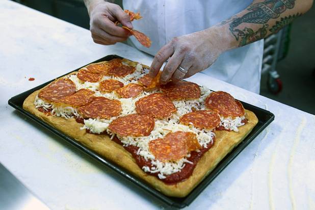 Tony Gemignani creates a Sicilian-style pizza at the new Pizza Rock restaurant at Third Street and Ogden Avenue in downtown Las Vegas Thursday, Oct. 17 2013.
