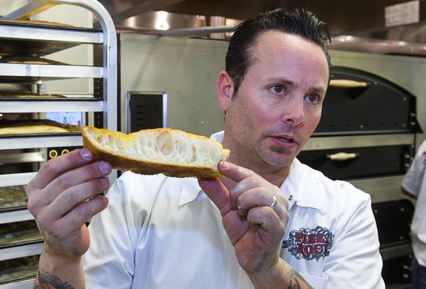 Tony Gemignani shows the holes in focaccia at the new Pizza Rock restaurant at Third Street and Ogden Avenue on Thursday, Oct. 17, 2013, in downtown Las Vegas.