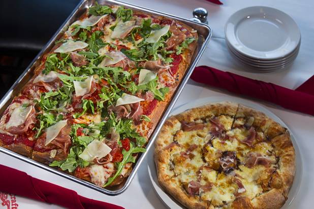 A Sicilian-style pizza, left, and a Cal Italia pizza are displayed at the new Pizza Rock restaurant at Third Street and Ogden Avenue in downtown Las Vegas Thursday, Oct. 17 2013.
