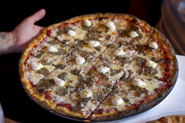 Tony Gemignani displays a Old Chicago pizza at the new Pizza Rock restaurant at Third Street and Ogden Avenue in downtown Las Vegas Thursday, Oct. 17 2013.