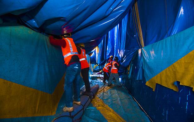 Circus Vargas crew members unfurl the sides of the big top from within its storage container as it is erected at the Galleria on Sunset parking lot Tuesday, Oct. 15, 2013.  L.E. Baskow.