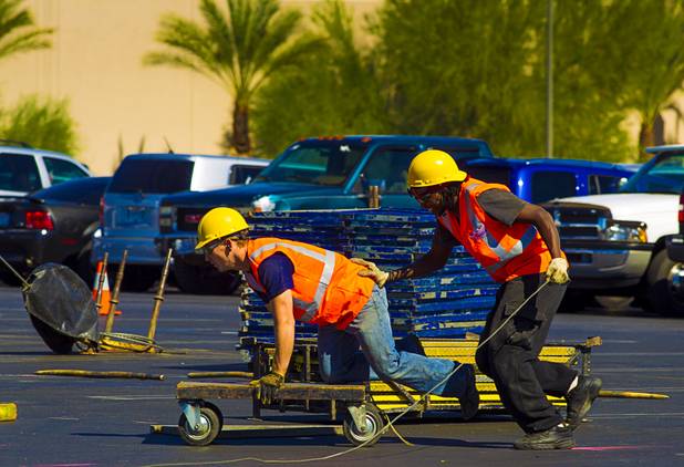 Christopher Ries and Marumbi Nzao of Circus Vargas play around on a cart as they join others in setting up the big top at the Galleria on Sunset Wednesday, Oct. 15, 2013.  L.E. Baskow.