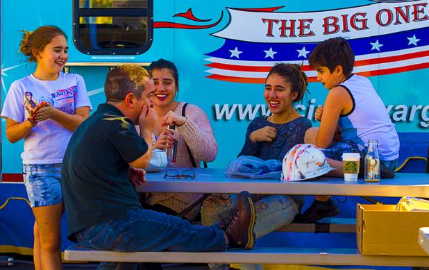(From left) Daniella Quiroga, Arturo Figueroa, Annabel Bachliyski, Mariella Quiroga and Anthony Bachliyski share some laughs as lunch for Circus Vargas members is about to be served Tuesday, Oct. 15, 2013.  L.E. Baskow.