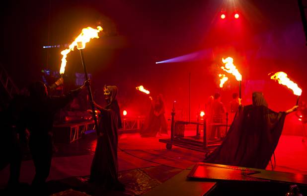 Flaming torches cast an eerie red glow as Circus Vargas magician Patrick gable amazes the crowd while performing at the Galleria on Sunset  Thursday Oct. 17, 2013.  L.E. Baskow.