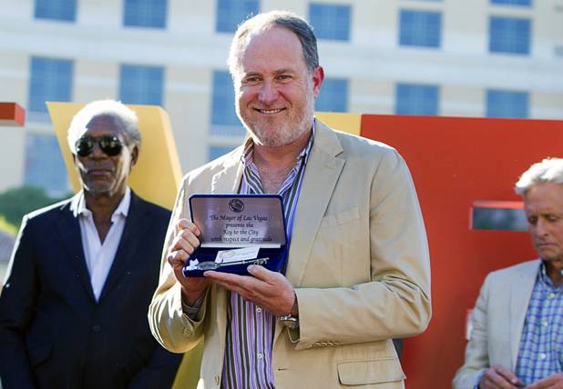 Director Jon Turteltaub poses with the Key to the City during a ceremony for Turteltaub and cast members of "Last Vegas" in front of the Bellagio Friday, Oct. 18, 2013. Behind Turteltaub are actors Morgan Freeman (L) and Michael Douglas. Las Vegas Mayor Carolyn Goodman and Clark County Commission Chairman Steve Sisolak declared Oct. 18, 2013 to be "Last Vegas Day" in Las Vegas and Clark County. The movie by CBS Films opens nationwide on November 1.
