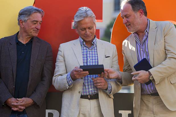 Robert De Niro, Michael Douglas and director Jon Turteltaub look over the "Key To the Las Vegas Strip" during a ceremony for Turteltaub and cast members of "Last Vegas" in front of the Bellagio Friday, Oct. 18, 2013. It was the first time for the Clark County to present a key. Las Vegas Mayor Carolyn Goodman and Clark County Commission Chairman Steve Sisolak declared Oct. 18, 2013 to be "Last Vegas Day" in Las Vegas and Clark County. The movie by CBS Films opens nationwide on November 1.