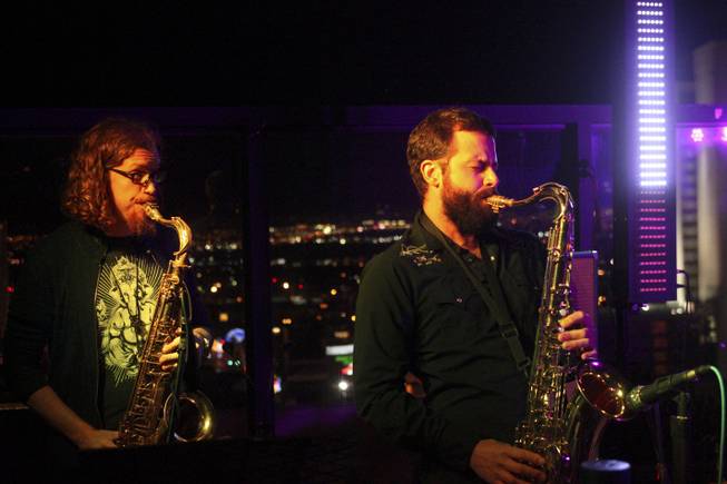 Moksha band members Eddie Rich, left, and Sam Lemos play sax during their set for the "Rooftop Fall Ball 3" on the Binion's Gambling Hall & Hotel rooftop pool deck, Friday, Oct. 18, 2013.