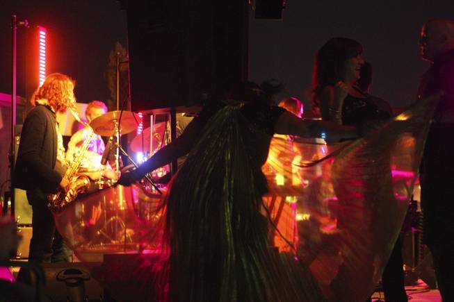 A fan with a cape dances during local band Moksha's set at the "Rooftop Fall Ball 3" on the Binion's Gambling Hall & Hotel rooftop pool deck, Friday, Oct. 18, 2013.