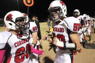 Coronado's Anthony Mollinedo, left, and Ryan Everette celebrate in the closing seconds of their game against Foothill Friday, Oct. 18, 2013. Coronado won the game 34-25.