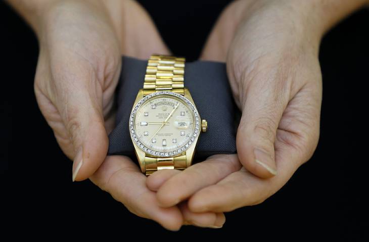 A Christie's specialist displays a Rolex watch given to Elvis Presley by his manager for Christmas in 1976, during a photocall at the auction rooms in London, Friday, Nov. 23, 2012. The watch estimated at 6,000- 8,000 pounds (9,500- 12,750 US Dollars) will go on sale in the Pop Culture auction on Nov. 29 in London.