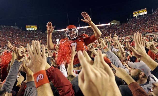 Utah quarterback Travis Wilson (7) is hoisted to the air by Utah fans after defeating Stanford 27-21 during an NCAA college football game Saturday, Oct. 12, 2013, in Salt Lake City.