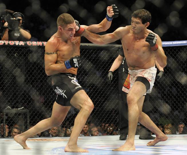 Gilbert Melendez, right, and Diego Sanchez fight in the second round of a UFC lightweight bout in Houston, Saturday, Oct. 19, 2013. Menendez won in a unanimous decision. (AP Photo/Pat Sullivan)