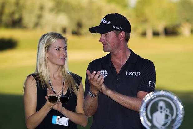 Webb Simpson of Charlotte, N.C. and his wife Dowd applaud during a trophy presentation ceremony after Simpson won the Shriners Hospitals for Children Open at TPC Summerlin Sunday Oct. 20, 2013.