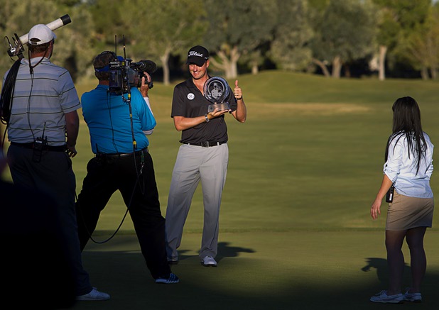 Webb Simpson of Charlotte, N.C. poses for a television cameraman after winning the Shriners Hospitals for Children Open at TPC Summerlin Sunday Oct. 20, 2013.