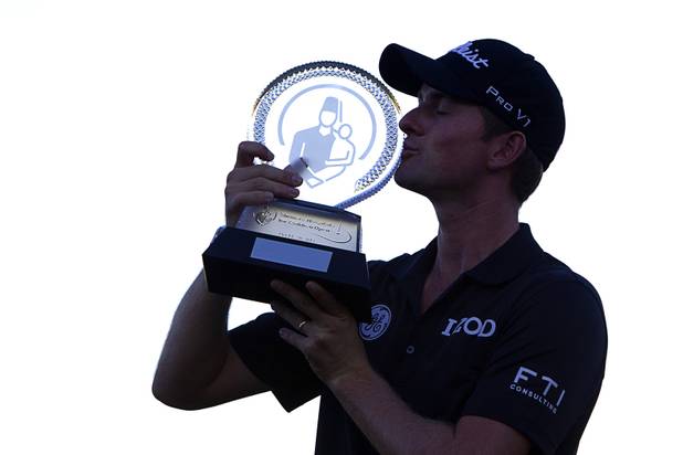 Webb Simpson of Charlotte, N.C. kisses his trophy after winning the Shriners Hospitals for Children Open at TPC Summerlin Sunday Oct. 20, 2013.