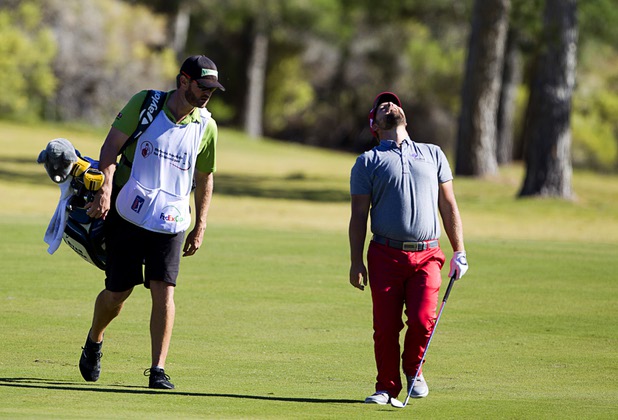 Defending champion Ryan Moore, right, or Las Vegas reacts after hitting on the 9th fairway during the Shriners Hospital for Children Open at TPC Summerlin Sunday Oct. 20, 2013.