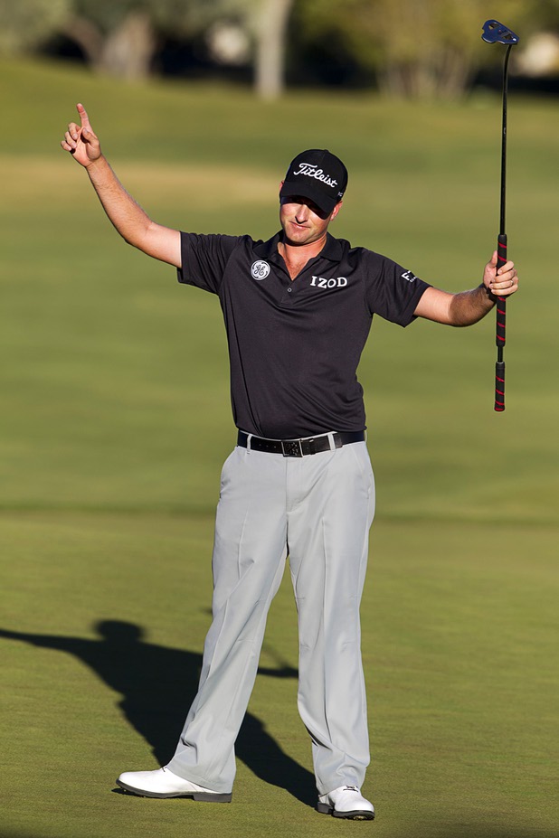 Webb Simpson of Charlotte, N.C. celebrates after sinking his birdie putt on the 18th green during the Shriners Hospital for Children Open at TPC Summerlin Sunday Oct. 20, 2013. Simpson ties tourney record to win Shriners Open by six strokes.