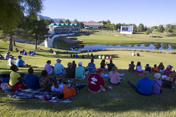 Spectators watch by the 18th green during the Shriners Hospital for Children Open at TPC Summerlin Sunday Oct. 20, 2013.