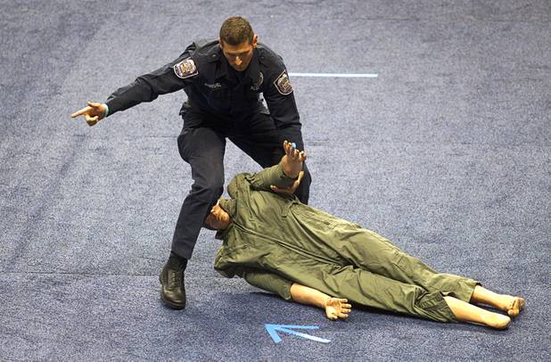 North Las Vegas K-9 Officer Paul Manteufel drags a dummy as he gives instructions to his dog (not pictured) during 23rd Annual Police K-9 Trials at the Orleans Arena Sunday, Oct. 20, 2013. Sixty teams from across the country participated in the trials. The event was sponsored by Friends for Las Vegas Police K-9's and hosted by the Las Vegas Metropolitan Police Department.