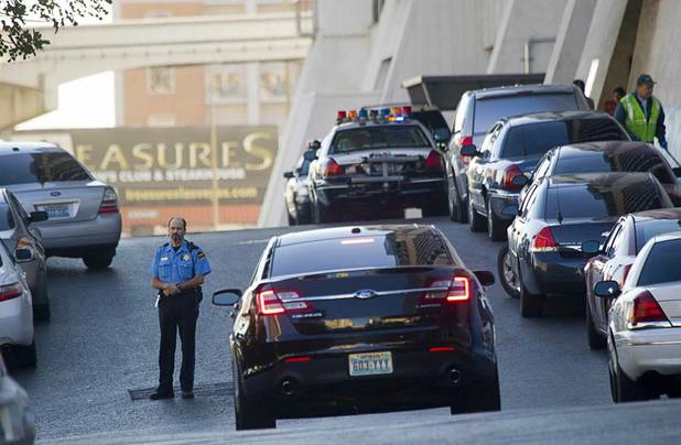 A security officer stands in front of Bally's after an early morning shooting left one person dead and two wounded in Drai's, a nightclub inside Bally's, Monday, Oct. 21, 2013. A suspect is in custody, police said.