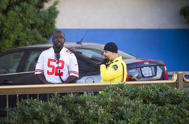 Hotel security officers stand near a Bally's entrance after an early morning shooting left one person dead and two wounded in Drai's, a nightclub inside Bally's, Monday, Oct. 21, 2013. A suspect is in custody, police said.