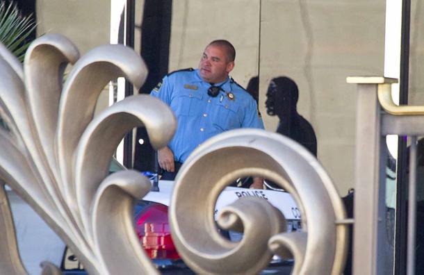 A hotel security officer stand at a Bally's entrance after an early morning shooting left one person dead and two wounded in Drai's, a nightclub inside Bally's, Monday, Oct. 21, 2013. A suspect is in custody, police said.