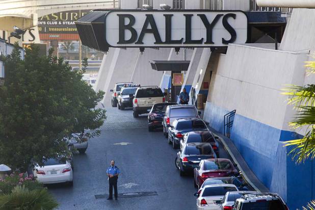 A hotel security officer stands near a Bally's entrance after an early morning shooting left one person dead and two wounded in Drai's, a nightclub inside Bally's, Monday, Oct. 21, 2013. A suspect is in custody, police said.