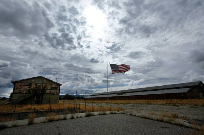 An American flag blows in the wind next to abandoned buildings in Jeffrey City, Wyo. Since 1980, residents in the former uranium mining town have dropped from 5,000 to about 50. With more uranium being discovered, some say the town might make a comeback. 