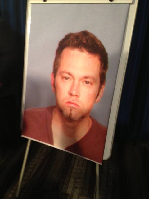 A poster of Benjamin Frazier, suspected in a shooting that killed one and injured two others Monday, Oct. 21, 2013, outside Drai's nightclub at Bally's, is displayed at a Metro Police news conference.