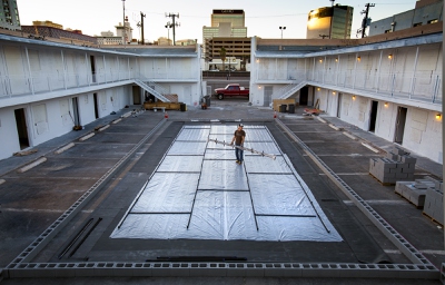 Artist Eric Tillinghast at work into the early evening on his fountain art piece Sump Lux for Life Is Beautiful in the Town Lodge Motel courtyard Tuesday, October 22, 2013 