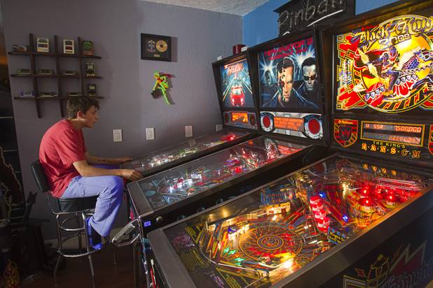 Craig Snelling's son Shane, 15, plays pinball in the game room Tuesday, Oct. 22, 2013. Snelling is a pinball machine repairman and owner of Billiards 'N More, a billiards and game room supply store.