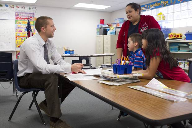 First grade teacher Charlie Lockwood talks with his student Angel Rosales, his mother Fabiola and his sister Marisol during a parent-teacher conference at Lois Craig Elementary School in North Las Vegas Wednesday, Oct. 23, 2013. Marisol helped with some translation. About 80 percent of students at the school are Hispanic.