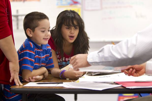 First grade student Angel Rosales and his sister Marisol look over one of Angel's compositions during a parent-teacher conference at Lois Craig Elementary School in North Las Vegas Wednesday, Oct. 23, 2013. Marisol helped her mother with some translation. About 80 percent of students at the school are Hispanic.