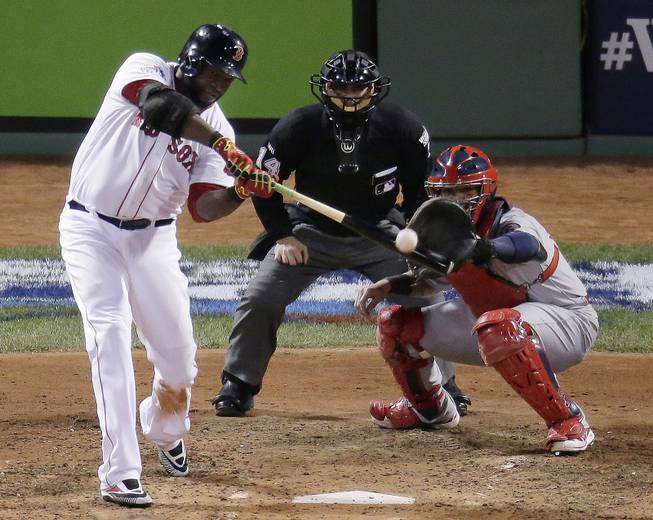 Boston Red Sox's David Ortiz hits a two-run home run during the sixth inning of Game 2 of baseball's World Series against the St. Louis Cardinals Thursday, Oct. 24, 2013, in Boston. 