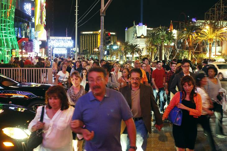 Pedestrians cross a driveway north of the MGM Grand on the Strip Friday, Oct. 25, 2013.