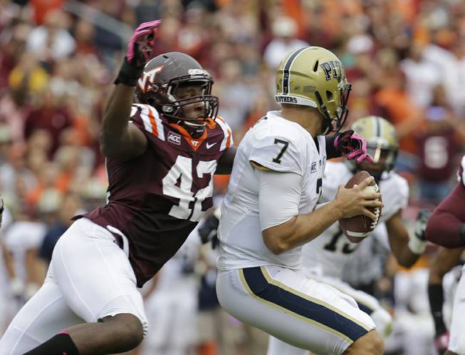 Virginia Tech defensive end J.R. Collins (42) pressures Pittsburgh quarterback Tom Savage (7) during the first half of an NCAA college football game in Blacksburg, Va., Saturday, Oct. 12, 2013. 