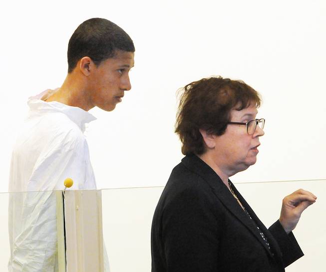 Philip Chism, 14, stands during his arraignment for the death of Danvers High School teacher Colleen Ritzer as his attorney Denise Regan speaks on his behalf in Salem District Court in Salem, Mass., Wednesday, Oct. 23, 2013. Chism has been ordered held without bail.