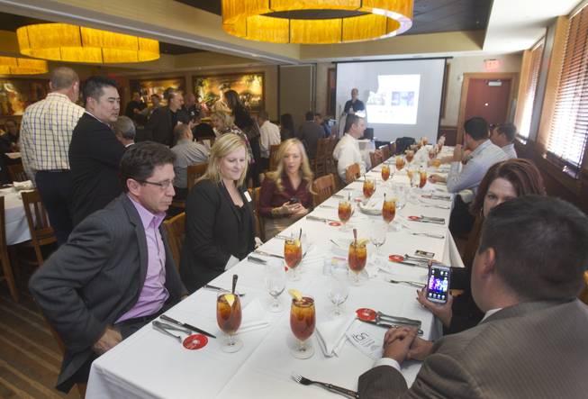 Businesspeople attend a networking luncheon sponsored by the Technology Business Alliance of Nevada at Fogo de Chao. Many expert networkers say they enjoy meeting over meals because of the intimacy a dining table creates. Others, however, say such a setting is confining.
