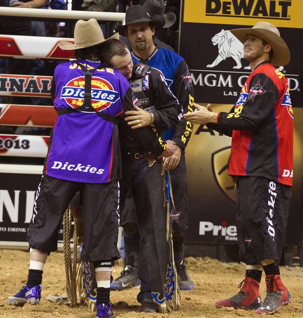 Brendon Clark is consoled in the ring after being bucked off during the 2013 PBR Built Ford Tough World Finals at the Thomas & Mack Center on Sunday, Oct. 25, 2013.