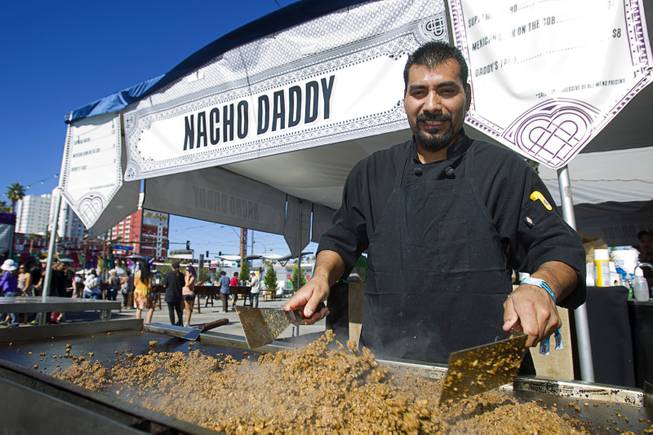Alfredo Garcia cooks up ground meat at the Nacho Daddy booth during the Life is Beautiful Festival in downtown Las Vegas Sunday, Oct. 27, 2012.