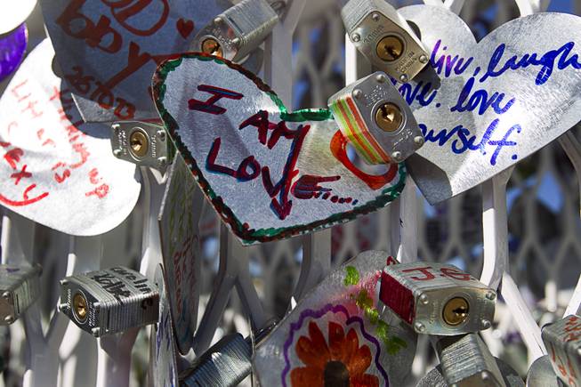 An art installation is shown during the Life is Beautiful Festival in downtown Las Vegas Sunday, Oct. 27, 2012. People create messages on heart-shaped, aluminum pieces that are padlocked onto the sculpture.