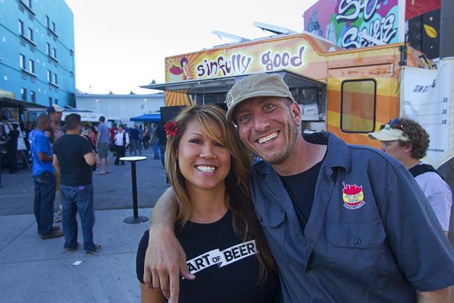 Mariann Lau poses with Tom Portnova, one of the owners of the Sin City Dogs food truck, during the Life is Beautiful Festival in downtown Las Vegas Sunday, Oct. 27, 2012.
